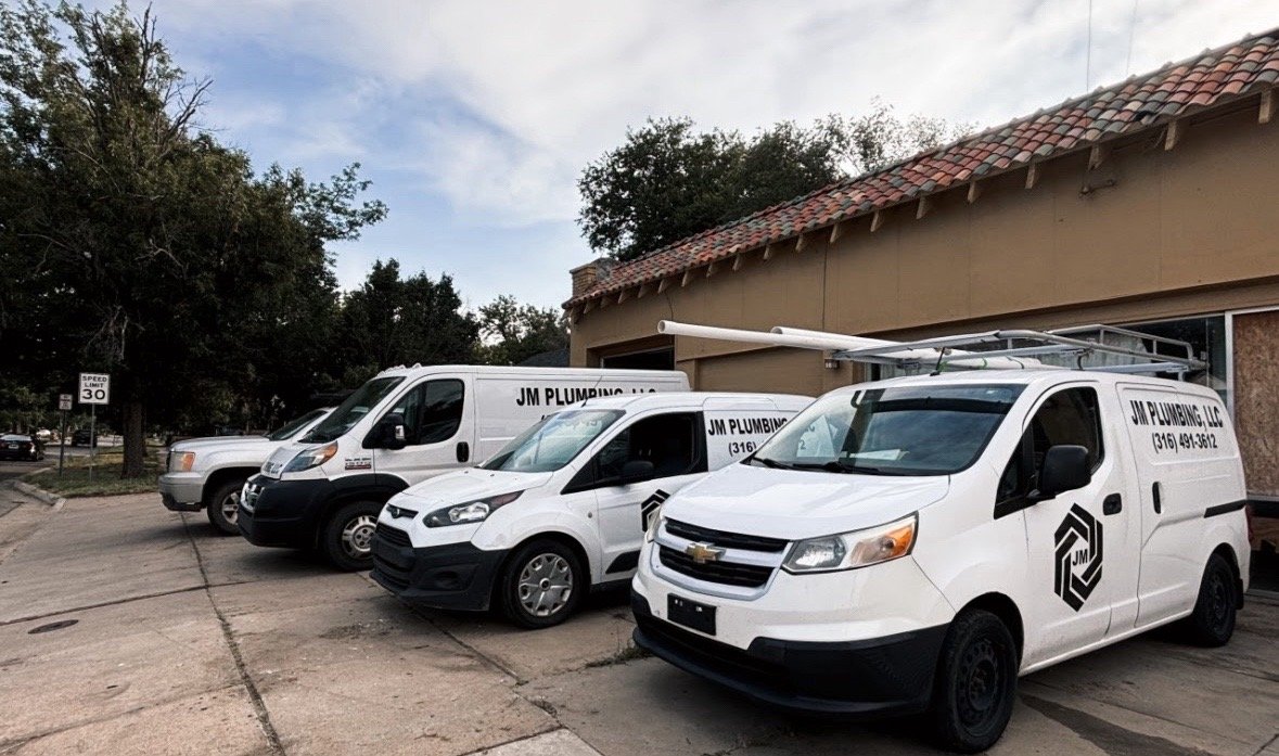 Fleet of JM Plumbing service vans